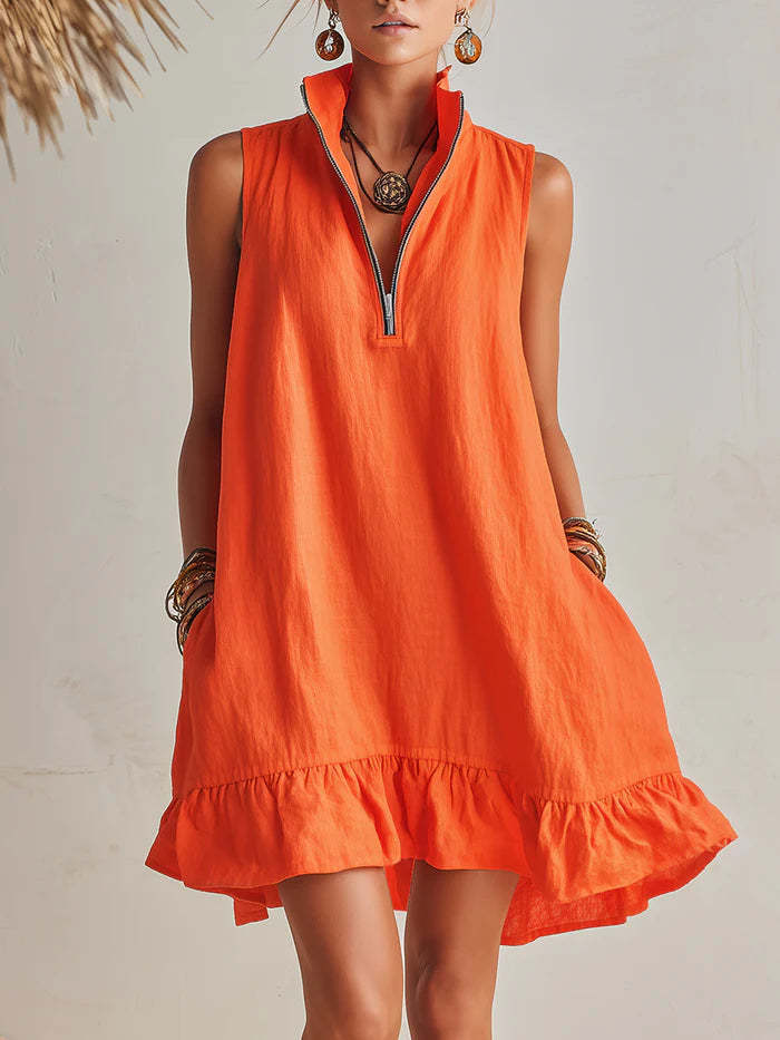 Orange sleeveless dress worn by a model against a neutral background