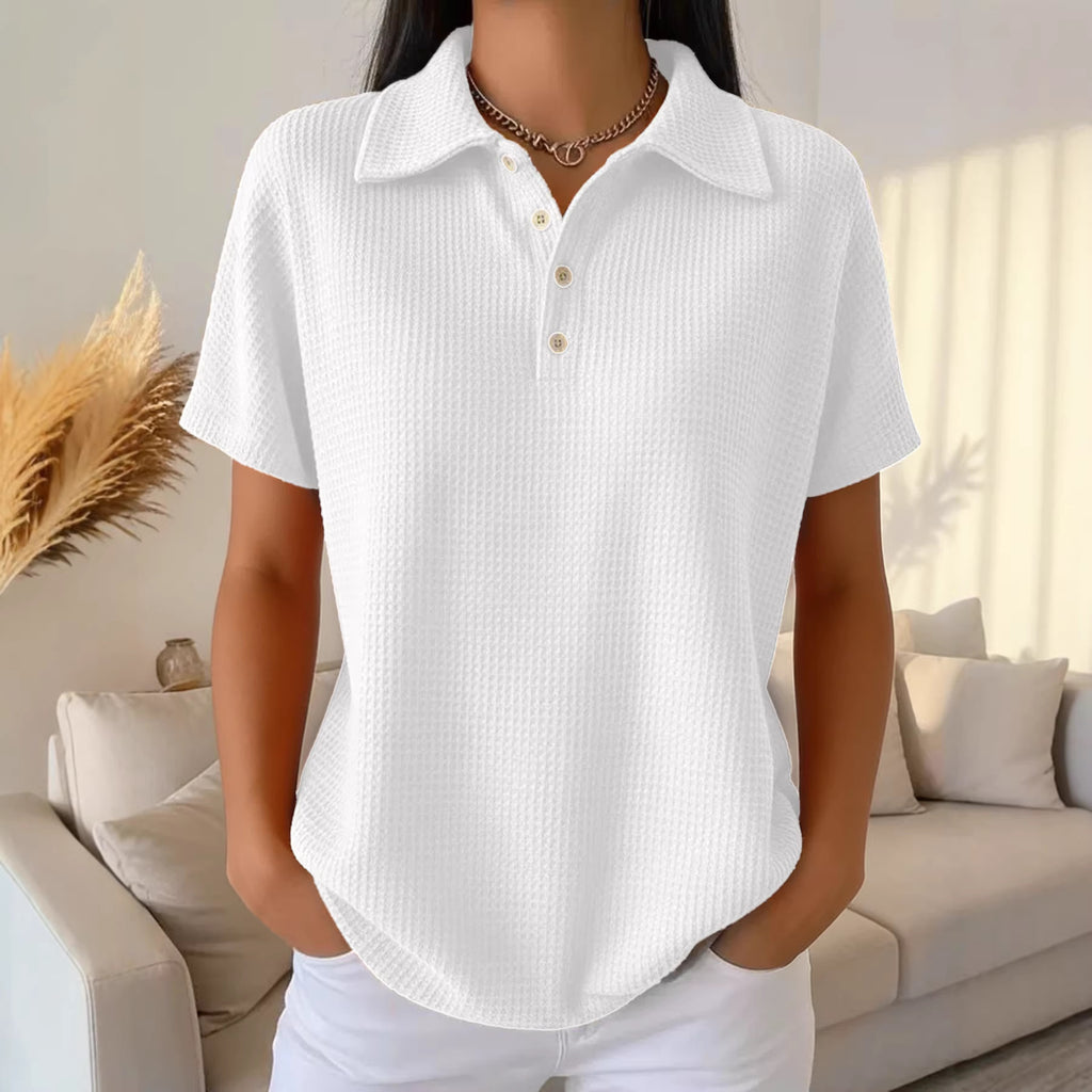Person wearing a white short-sleeve shirt in a living room setting