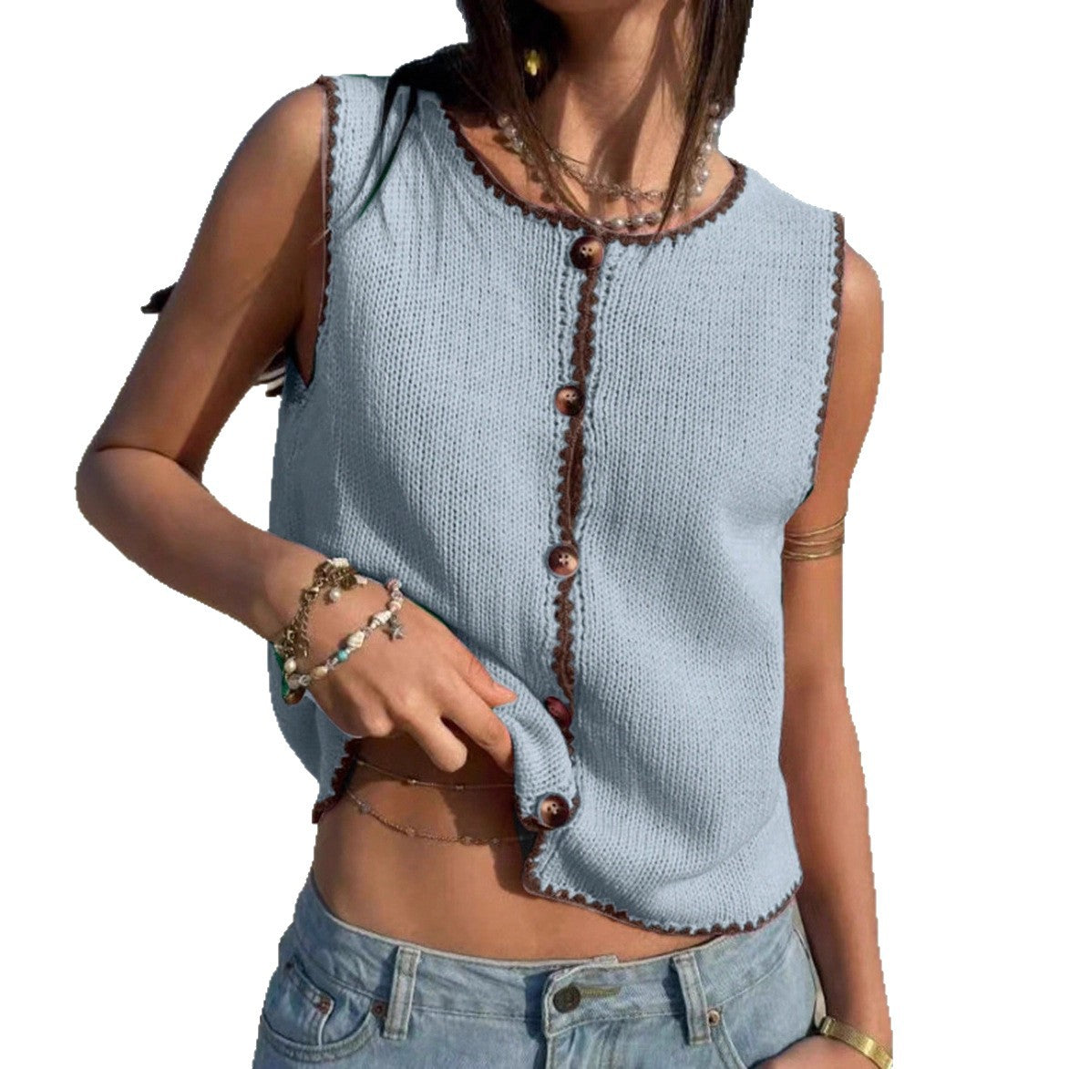 Light blue sleeveless knitted top with brown buttons worn by a person on a white background