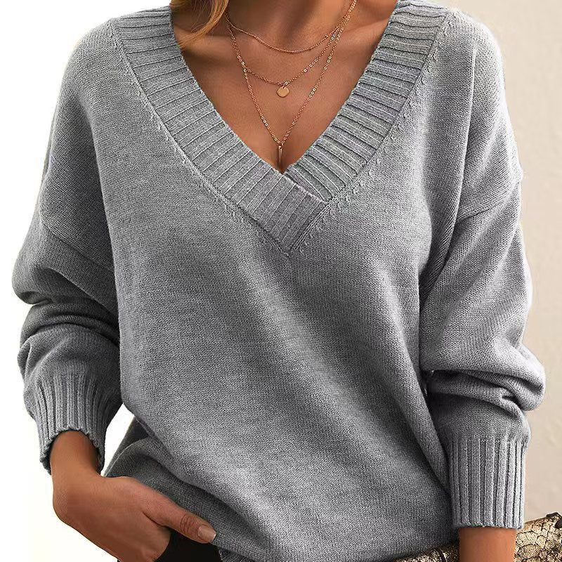 Gray sweater worn by a person with a neutral background