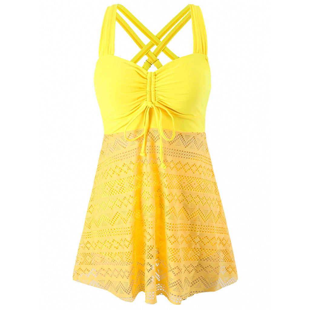 Yellow lace dress with criss-cross straps on a white background