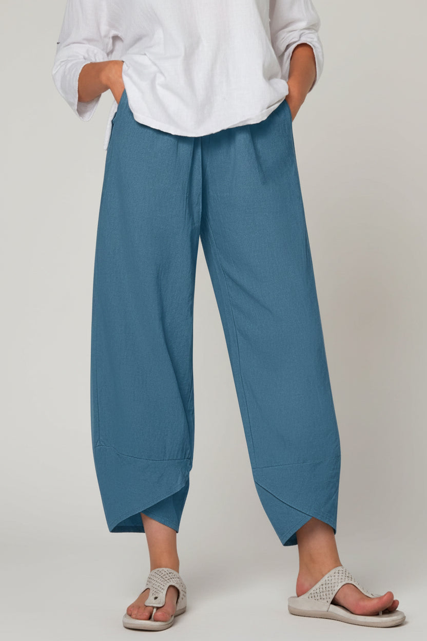 Person wearing blue pants and a white shirt on a white background