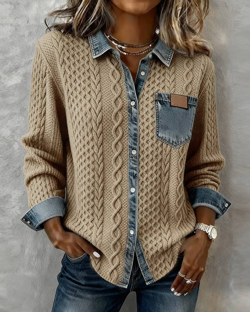 Person wearing a beige cable knit cardigan over a denim shirt with a neutral background