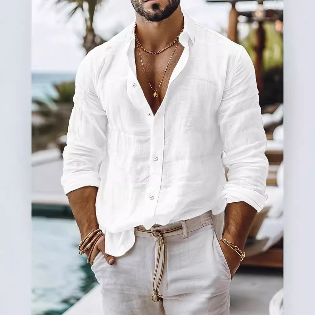 Man wearing a white shirt and beige pants with a blurred background