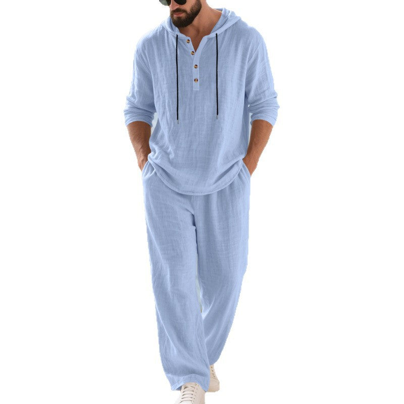 Man wearing a light blue hoodie and pants set on a white background