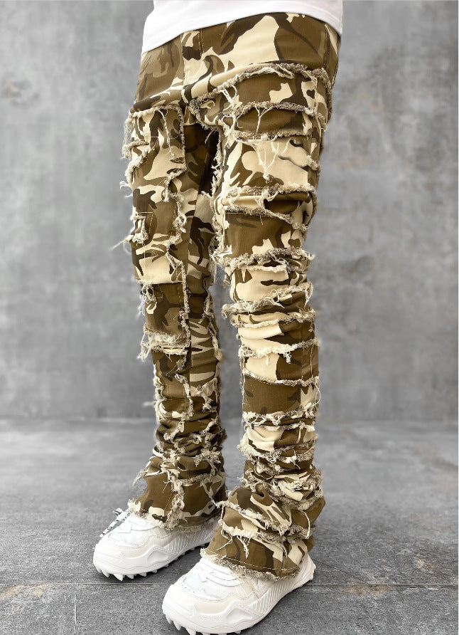 Camouflage pants worn by a person on a gray background