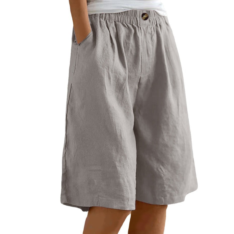 Gray shorts worn by a person on a white background