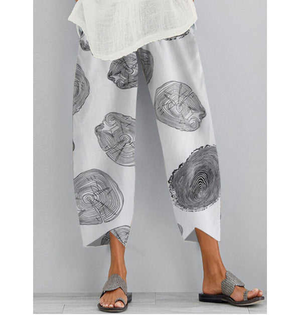 White pants with black tree ring pattern worn by a person on a gray background