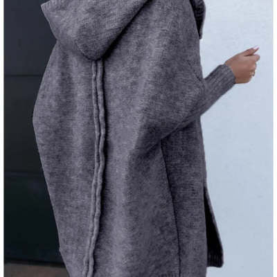 Gray hooded coat worn by a person against a light blue background
