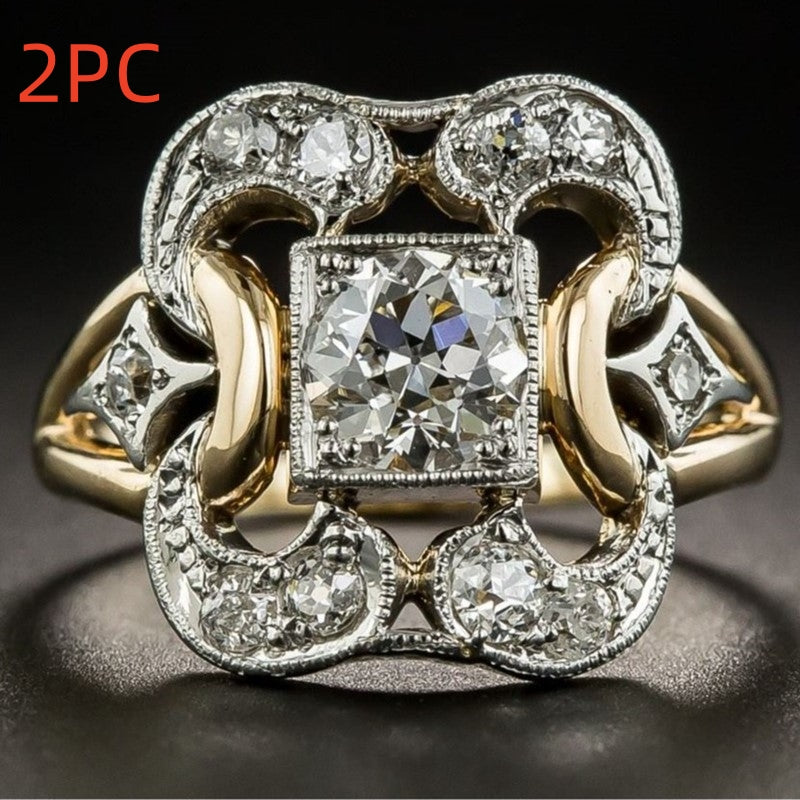 Gold and silver ring with diamonds on a dark background