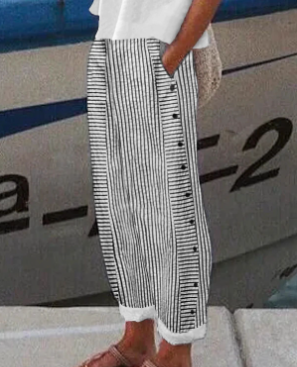 Person wearing black and white striped pants with a blurred background