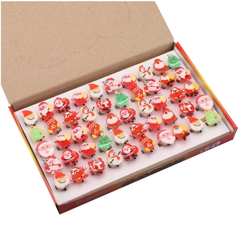 Box of small figurines with Santa Claus design on a white background
