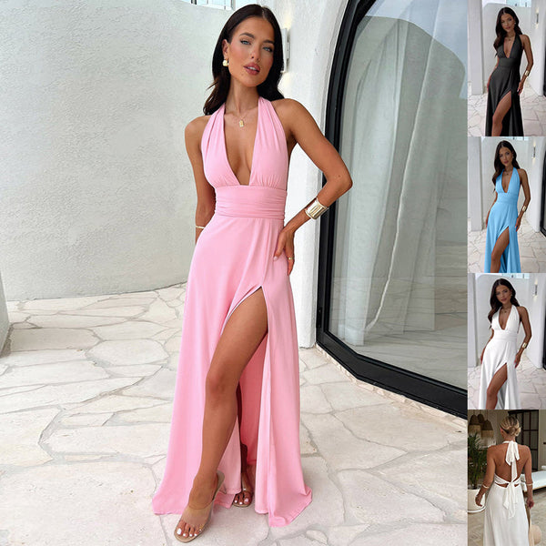 Woman in a pink dress with a slit standing in a modern interior setting.