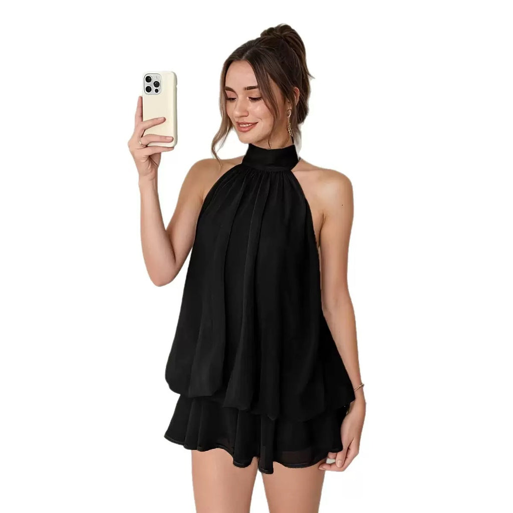 Woman wearing a black halter top and shorts on a white background