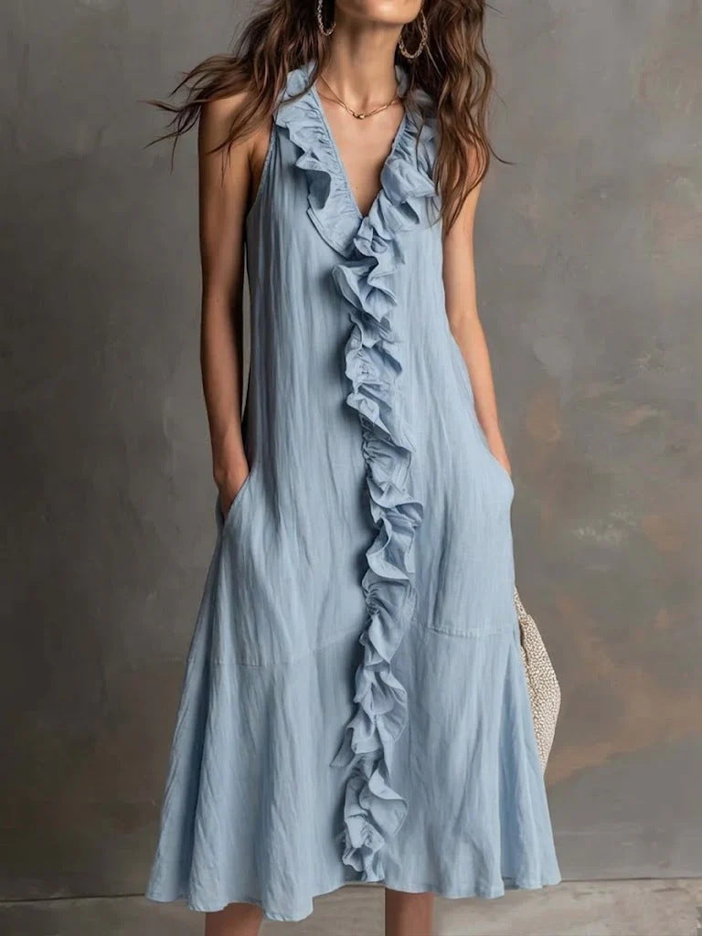 Light blue ruffled dress worn by a person against a neutral background