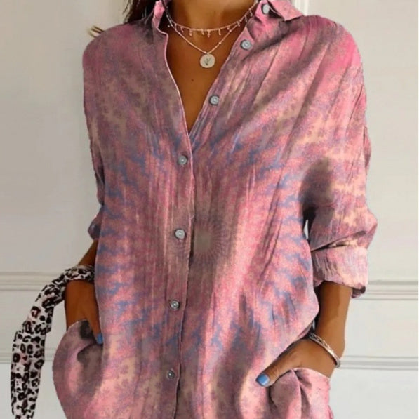 Person wearing a pink and purple patterned shirt with a white background