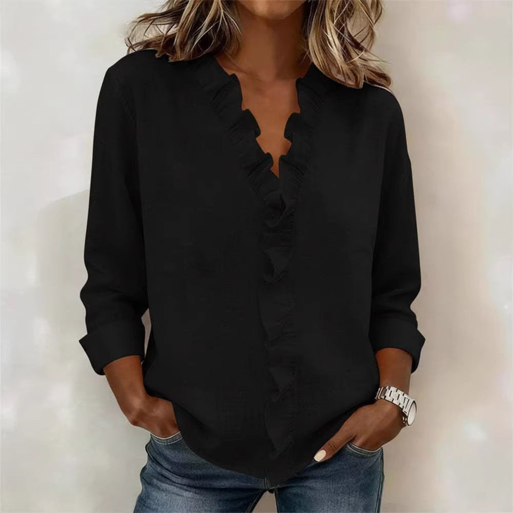 Person wearing a black blouse with a plain background