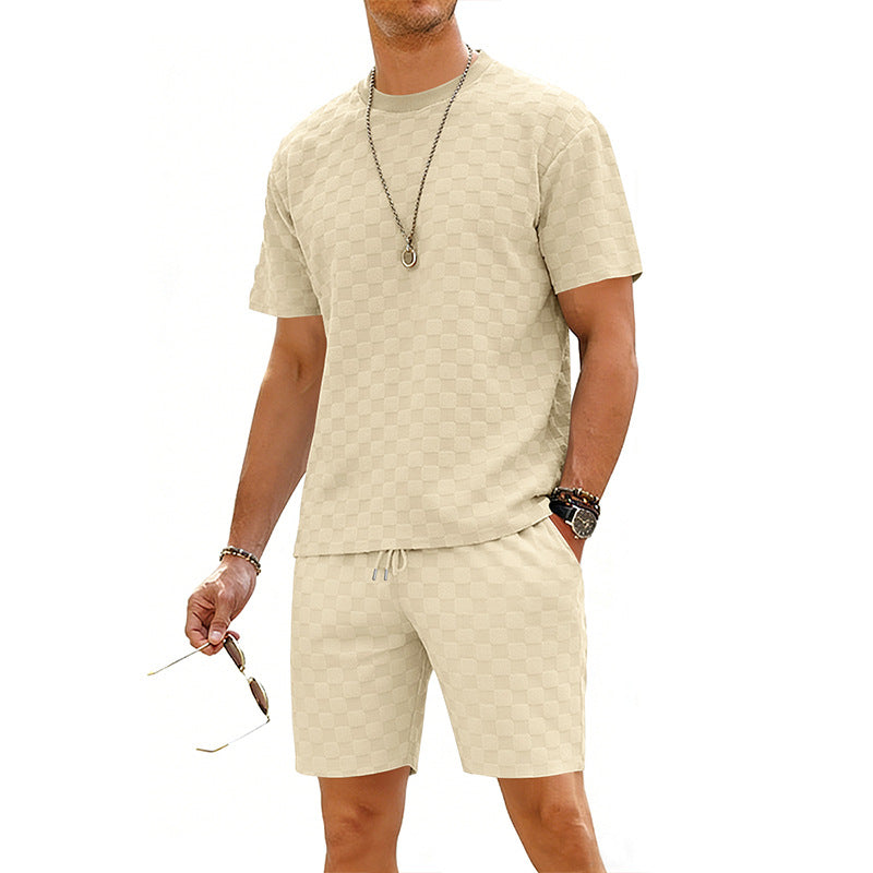 Man wearing a beige patterned t-shirt and shorts set on a white background