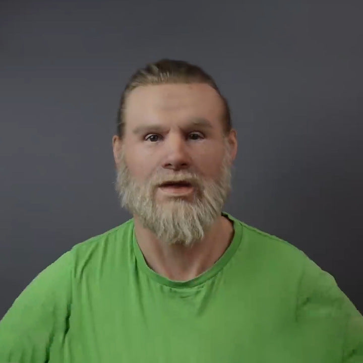 Man with a beard wearing a green shirt against a dark background