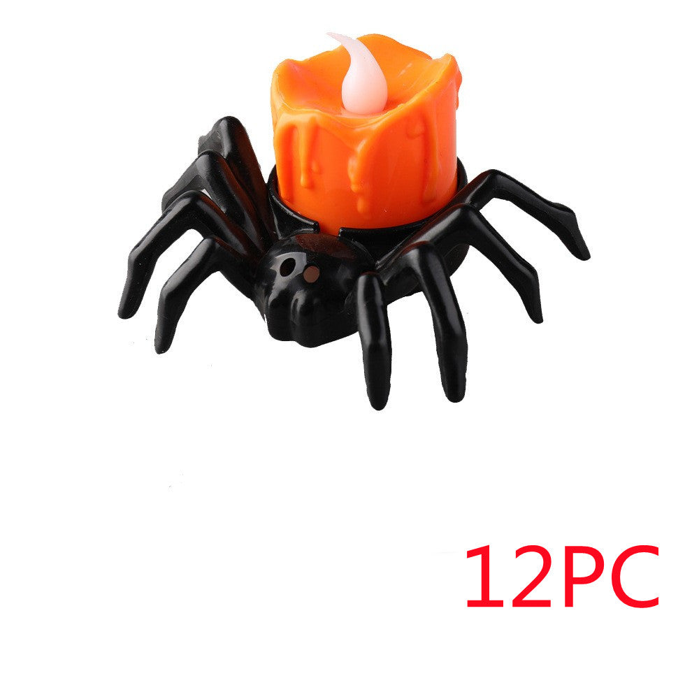 Spider-shaped candle holder with an orange candle on a white background, labeled '12PC'.