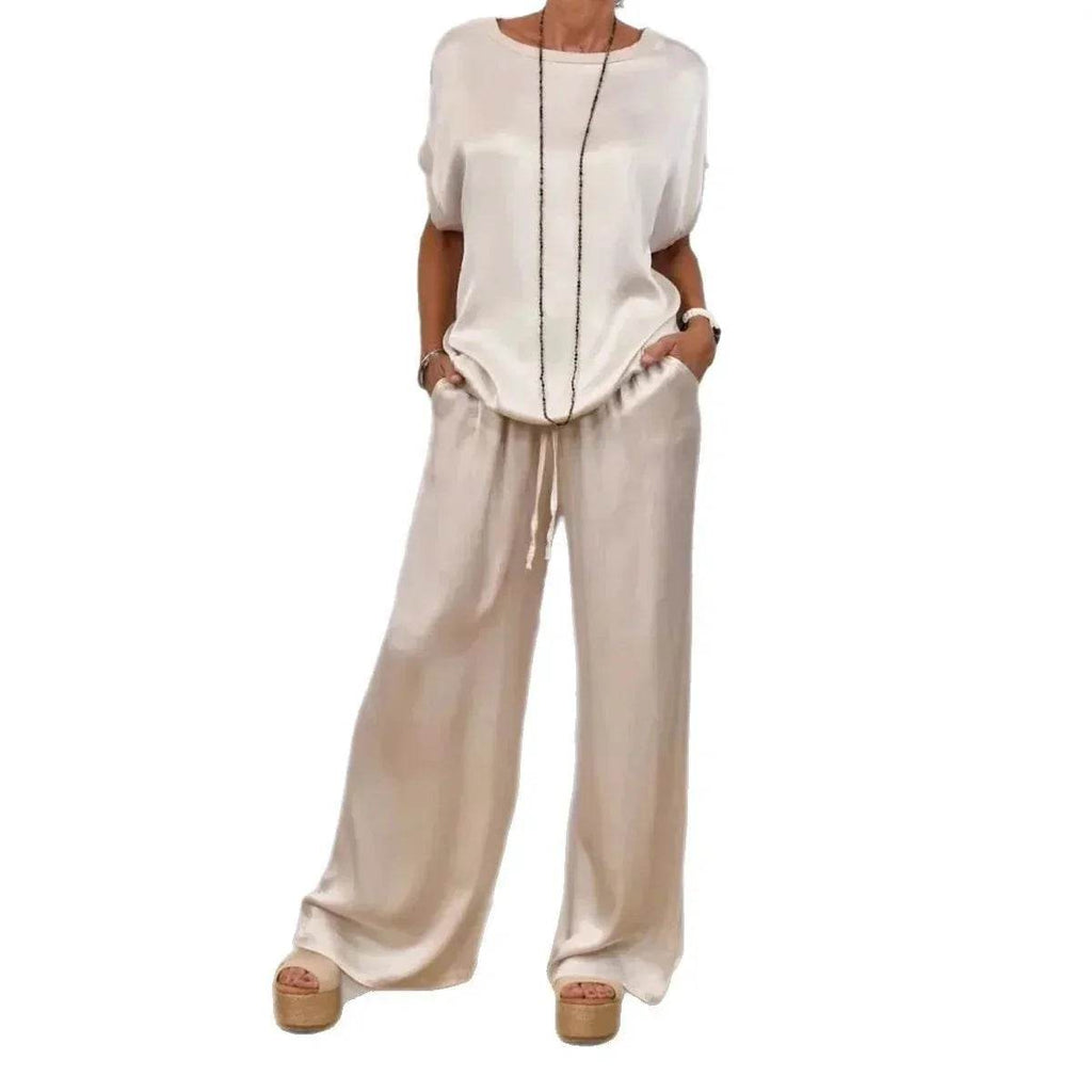 Woman wearing chic ivory satin top and wide-leg pants set from ZA-Zola fashion UK