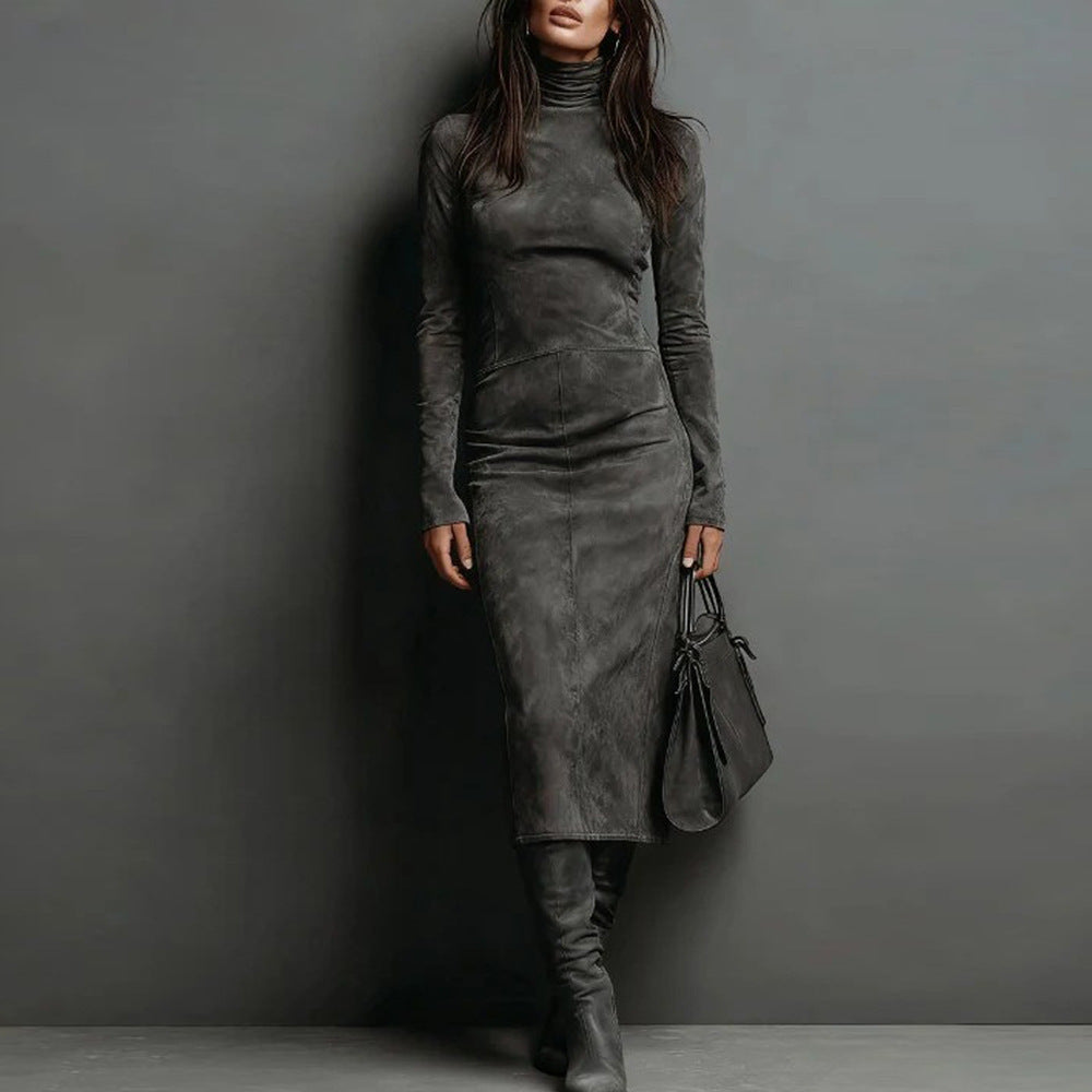 Woman wearing a gray suede dress and boots against a dark gray background