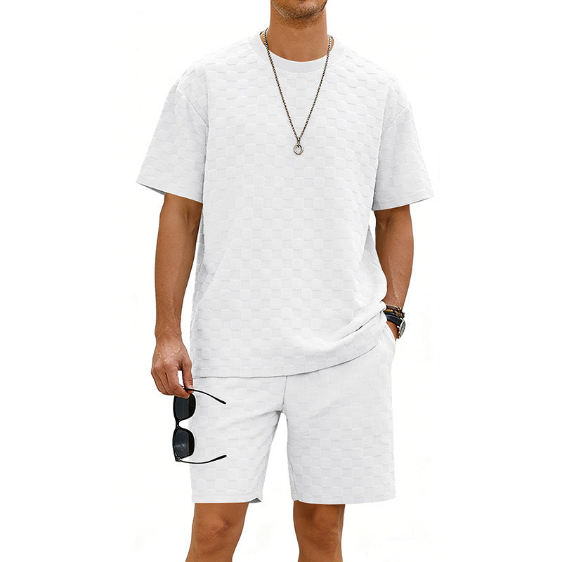 Person wearing a white t-shirt and shorts set with sunglasses on a white background
