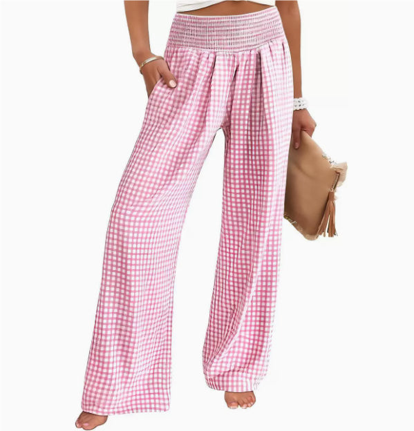 Pink and white checkered pants worn by a person on a white background