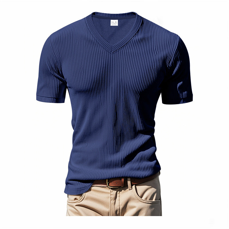 Blue ribbed t-shirt worn with beige pants on a white background