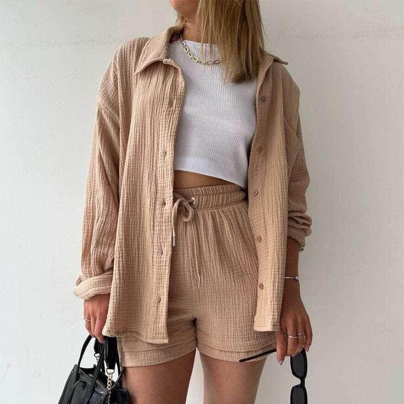 Woman in beige textured shorts set, white crop top, holding black bag, ZA-Zola fashion