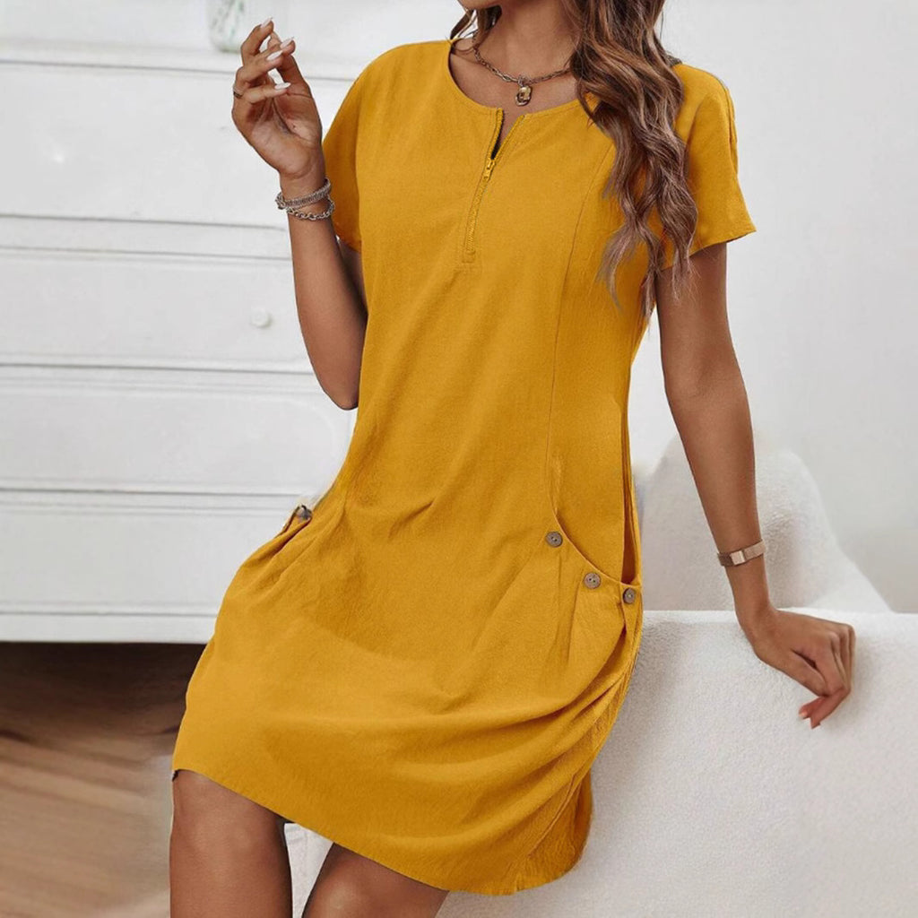 Woman wearing a mustard yellow dress with a white background