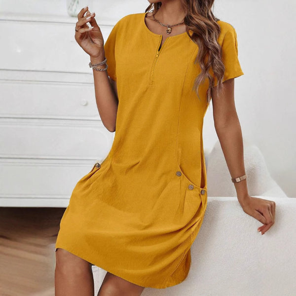 Woman wearing a mustard yellow dress with a white background