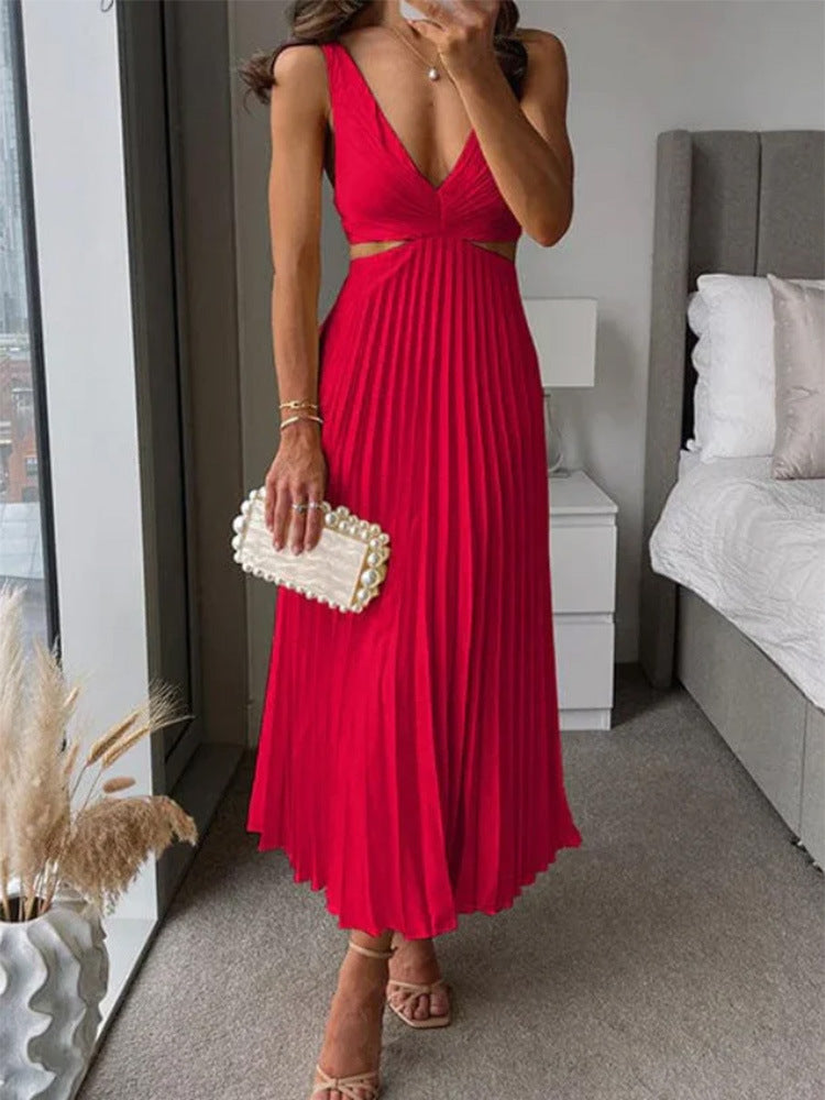 Woman in a red dress holding a clutch in a bedroom setting