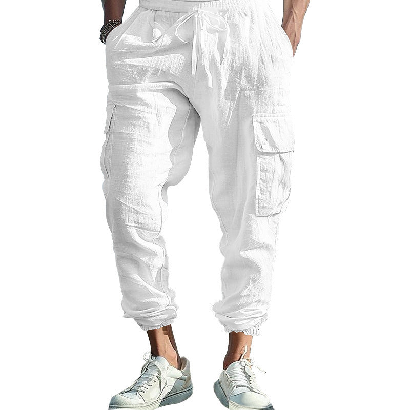 White cargo pants worn by a person on a white background