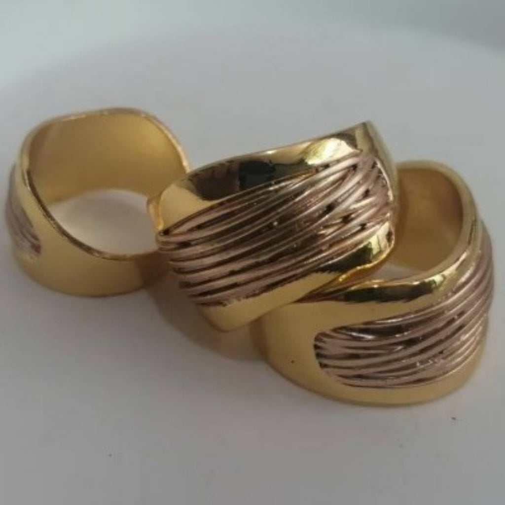 Two gold rings with textured design on a white background