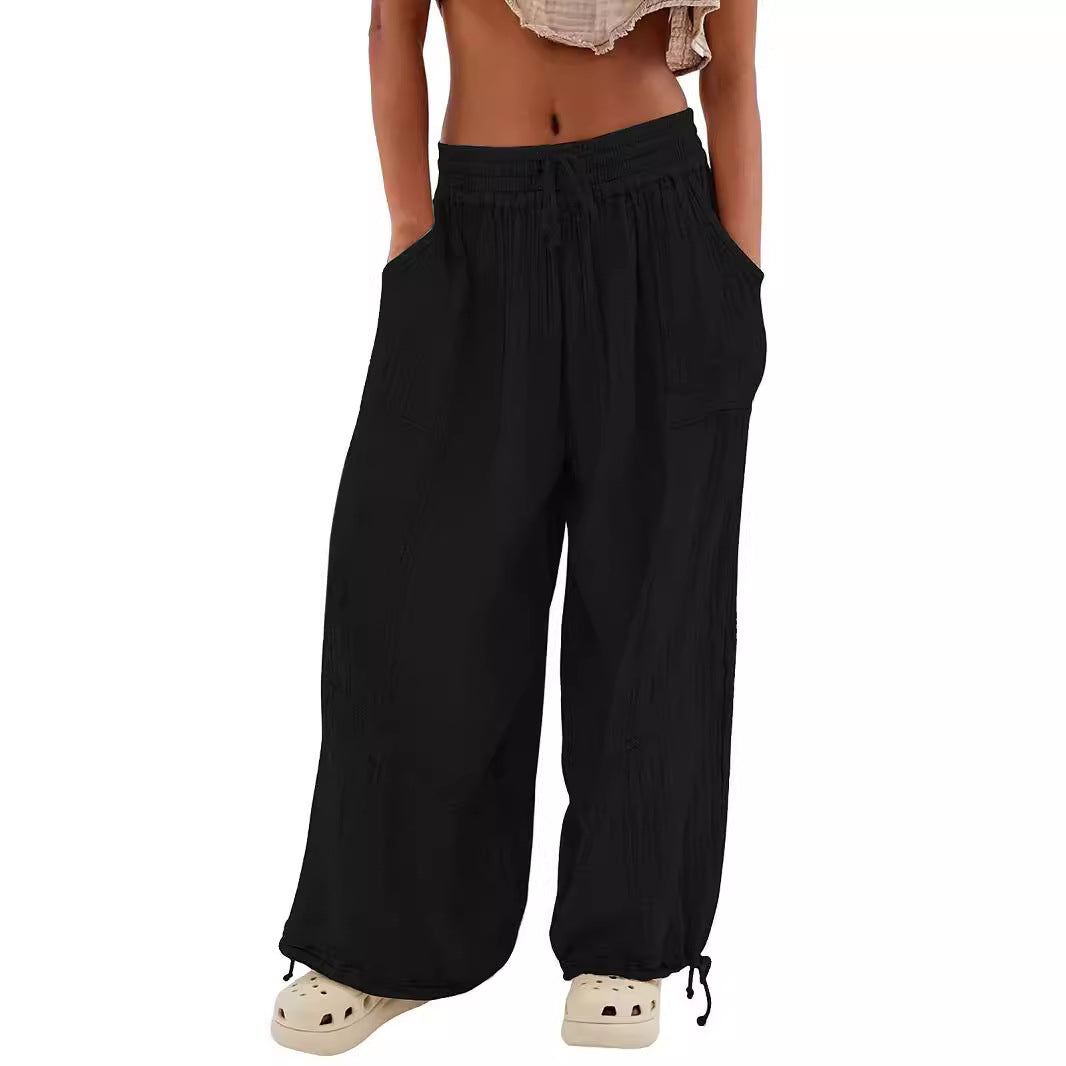 Navy blue wide-leg pants worn by a person on a white background