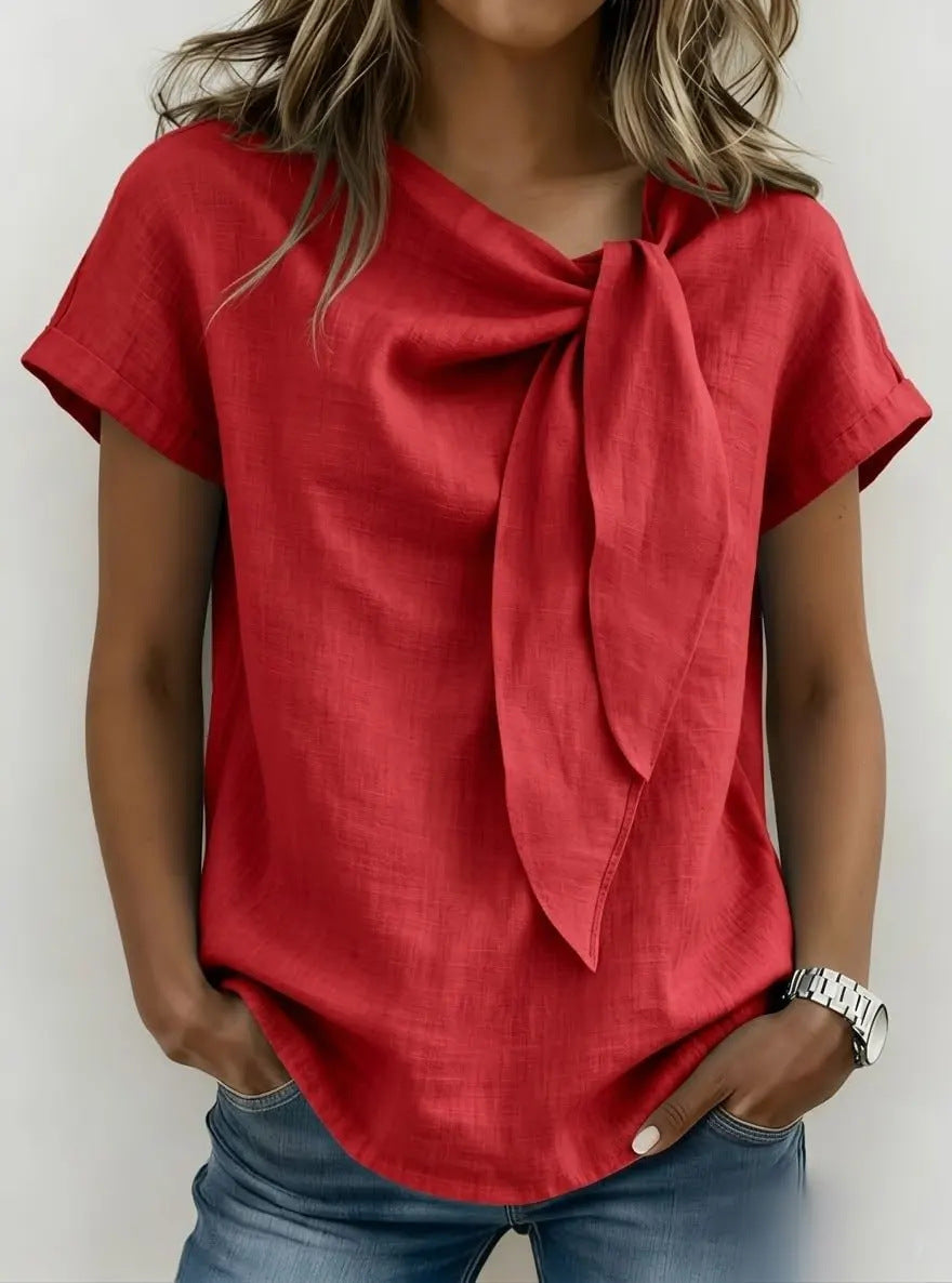 Red top with a bow tie worn by a person against a white background