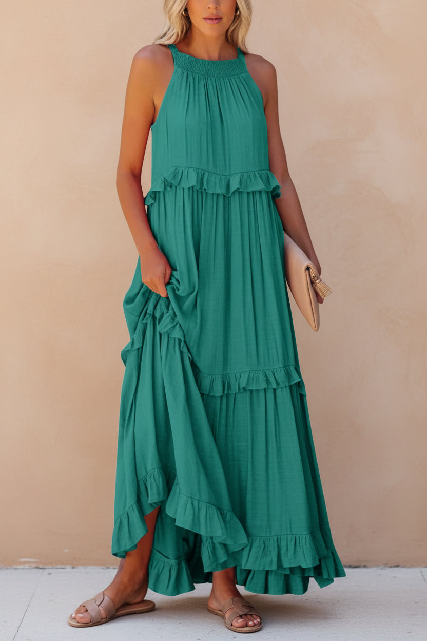Woman wearing a green tiered dress on a white background
