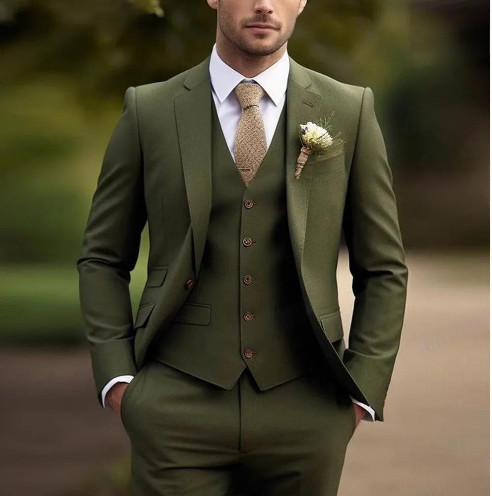Man wearing a green suit with a tie and boutonniere against a blurred natural background