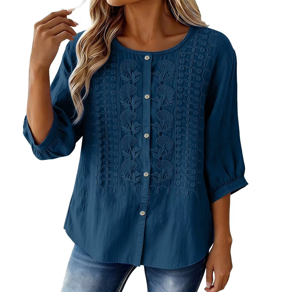 Blue blouse with intricate patterns on a white background