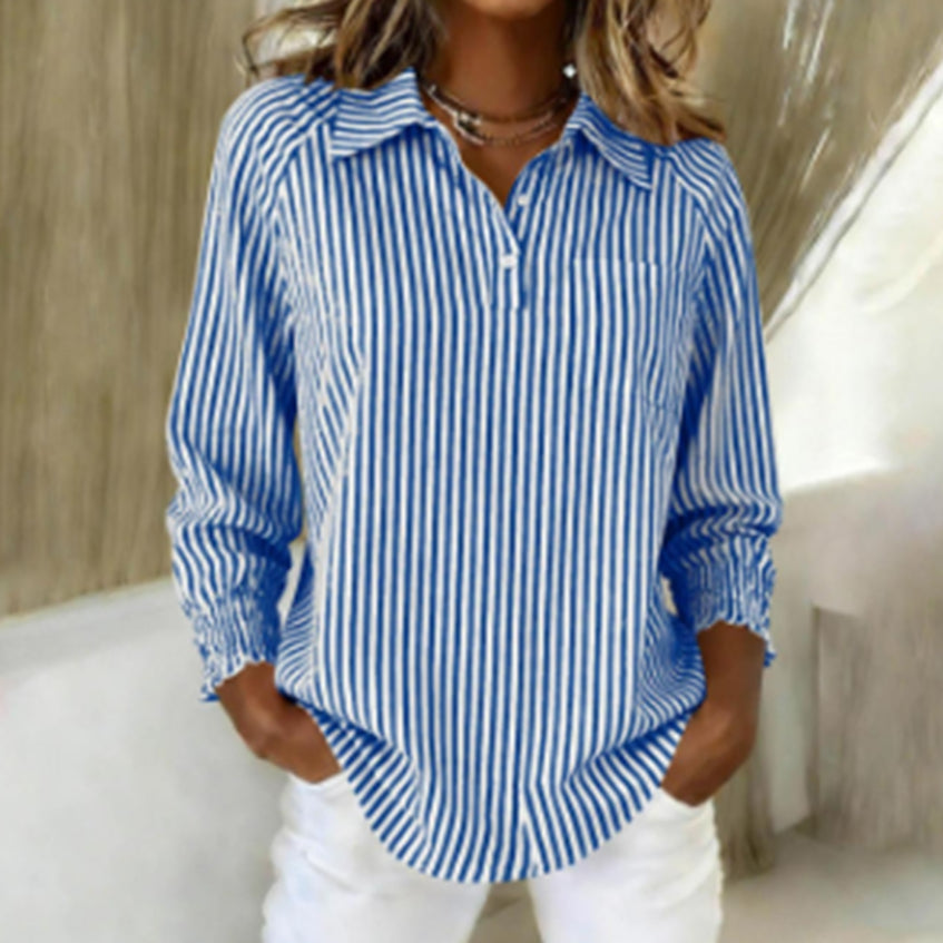 Woman wearing a blue and white striped shirt with a neutral background