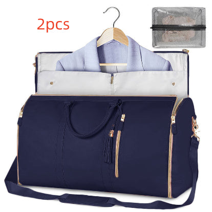 Navy blue travel bag with a shirt, hanger, and mesh pouch on a white background