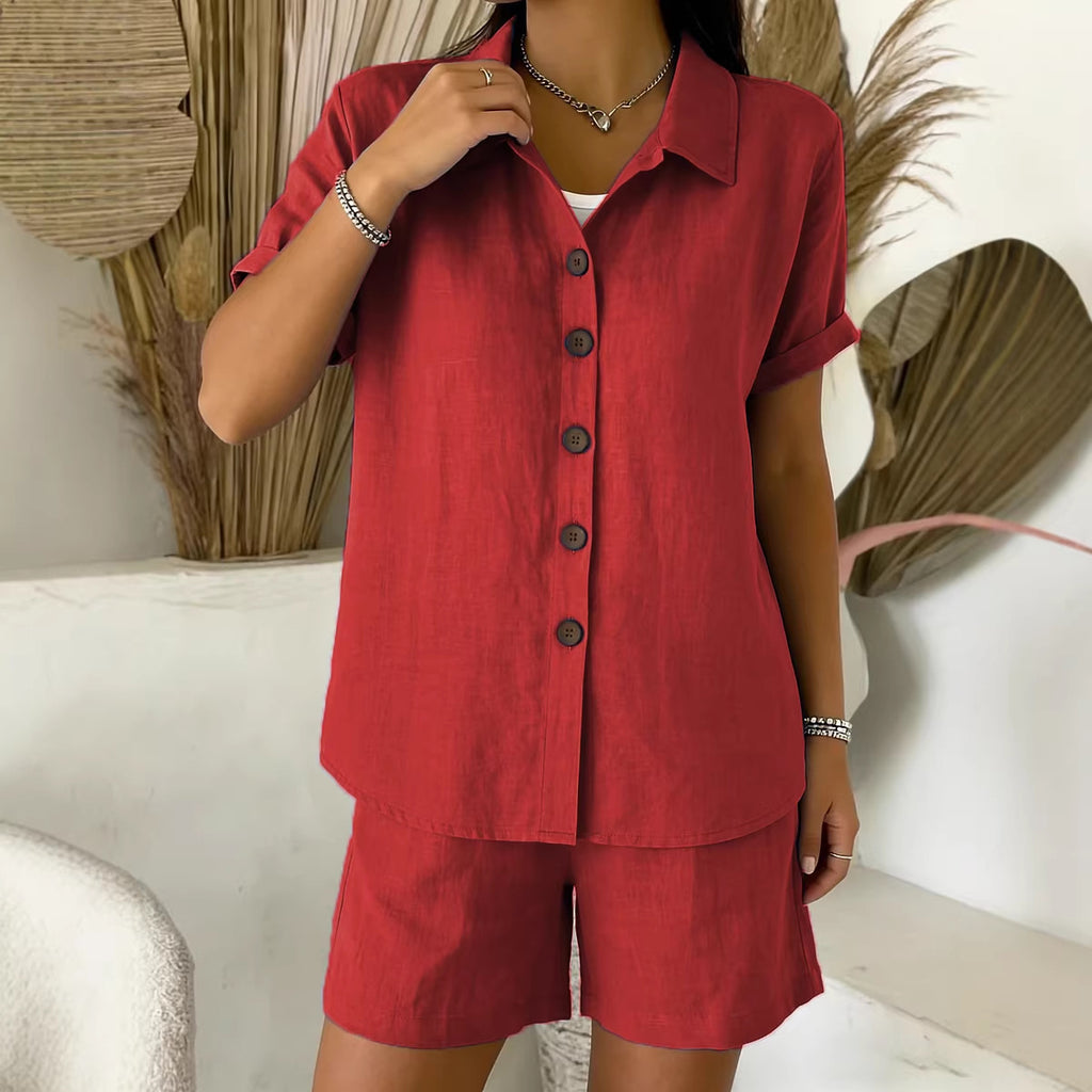 Person wearing a red outfit with a matching shirt and shorts in a minimalistic setting.