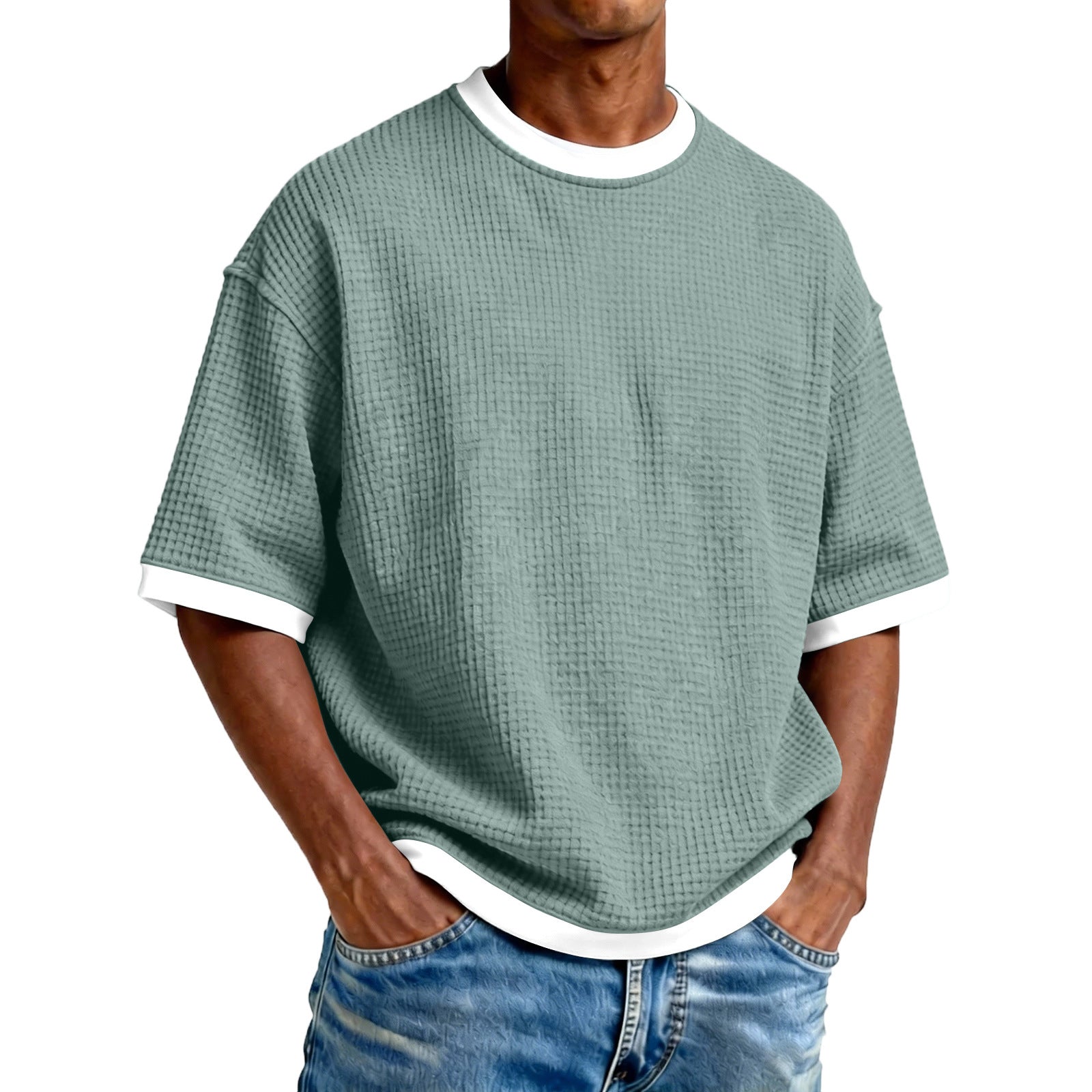 Person wearing a green textured t-shirt with white trim on a white background