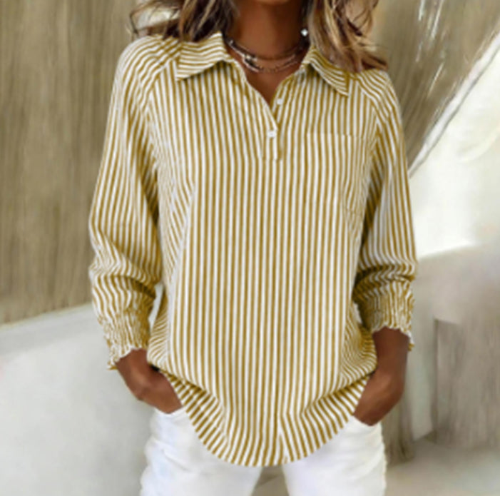 Woman wearing a yellow and white striped shirt with a neutral background