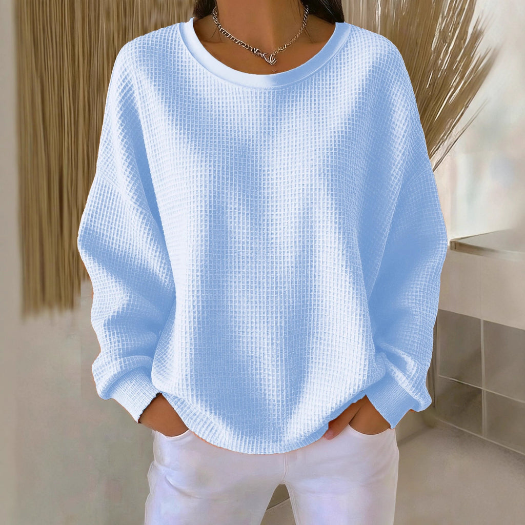 Light blue textured sweater worn by a person indoors.