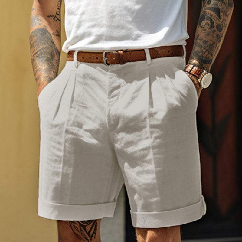 Person wearing white shorts and a white shirt with tattoos on arms and legs.