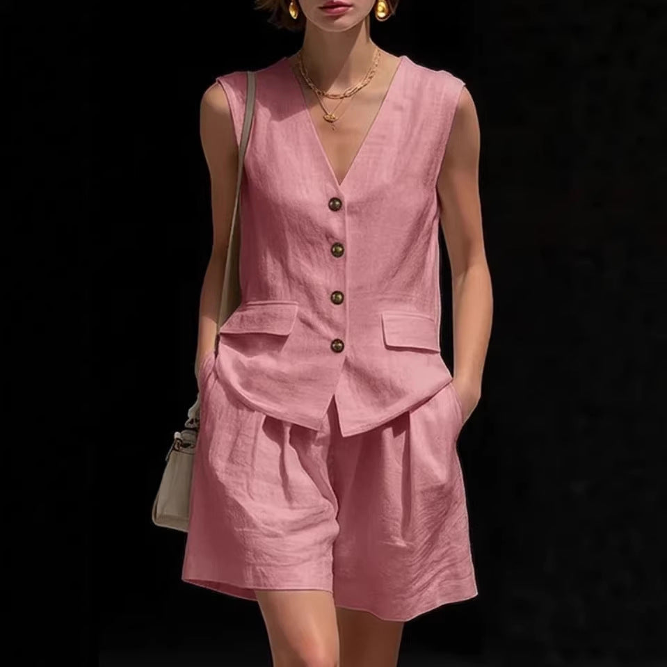 Woman wearing a pink linen suit with a black background