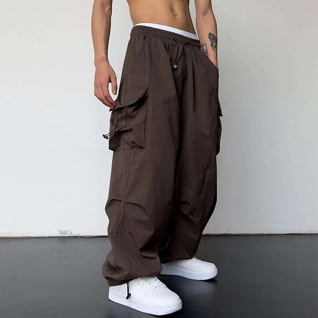 Brown baggy pants worn by a person on a plain background