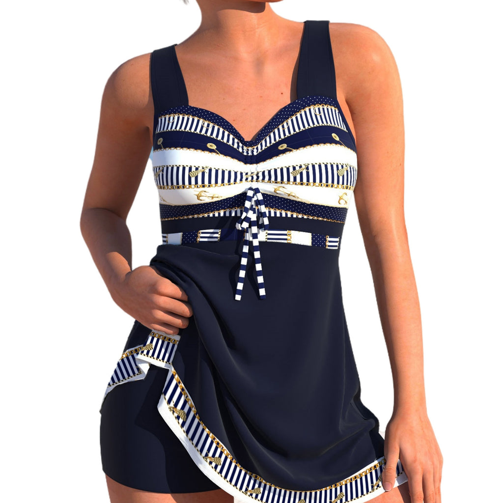Navy and white patterned dress with a belt on a white background